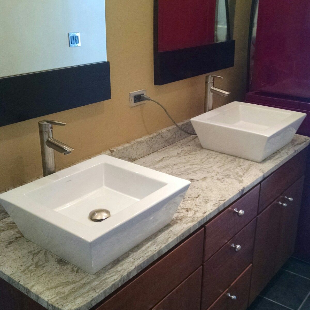 Modernized bathroom with granite tops and top mount ceramic sinks